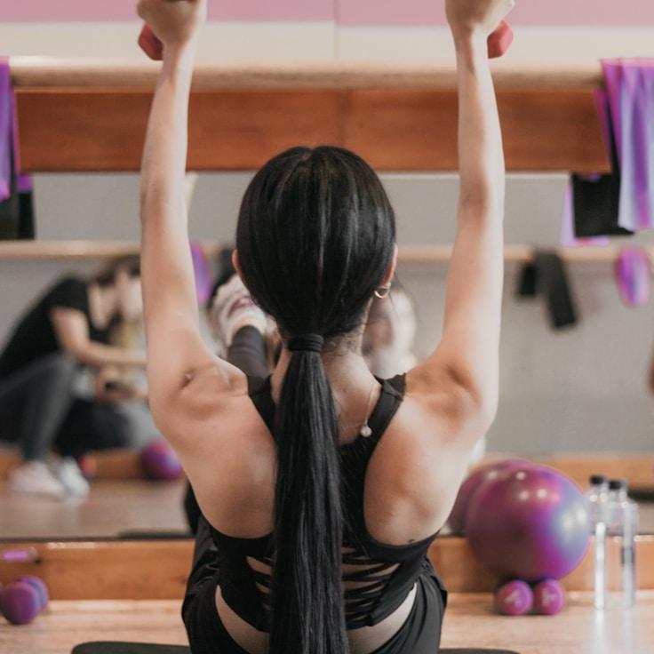 Women in a fitness class doing stretching and mobility exercises